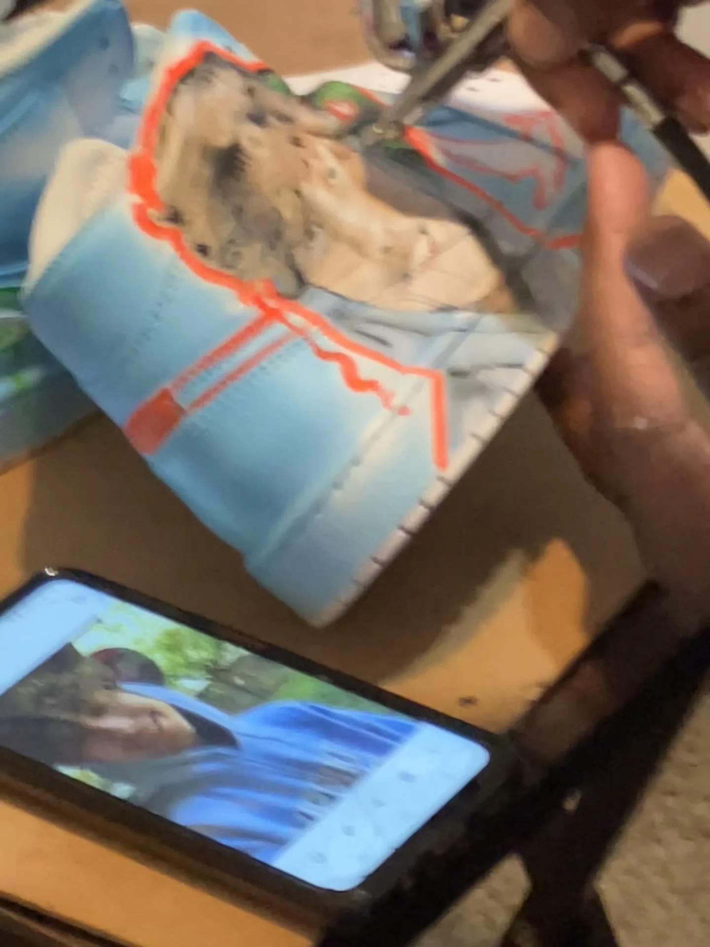 Close-up of a custom sneaker being painted
