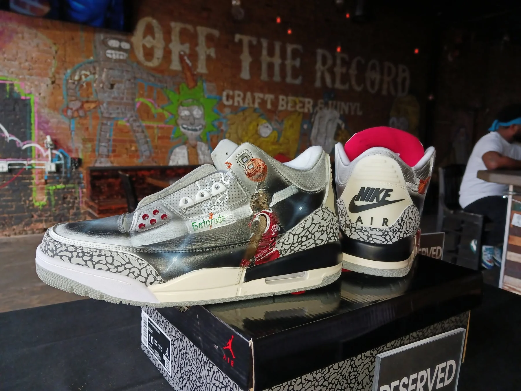 Custom sneaker artwork displayed at an event