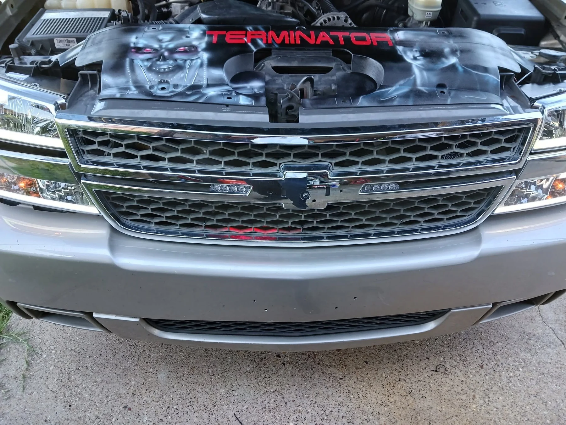 Custom airbrushed artwork across a vehicle hood