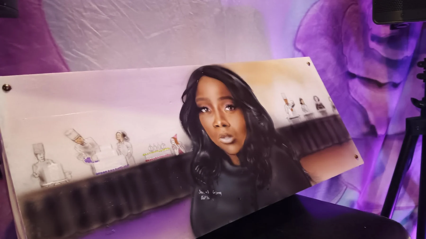 Live event guest holding custom artwork